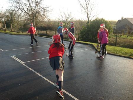 P6 & P7 enjoying a game of hurling during PE.