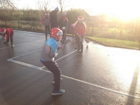 P6 & P7 enjoying a game of hurling during PE.