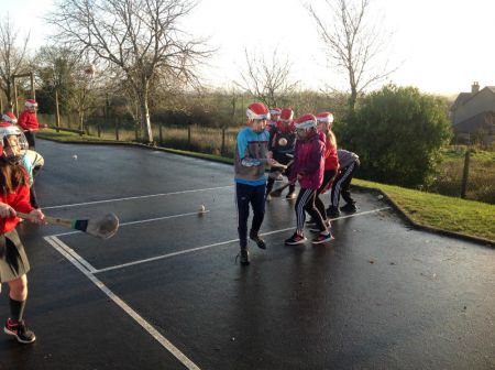 P6 & P7 enjoying a game of hurling during PE.