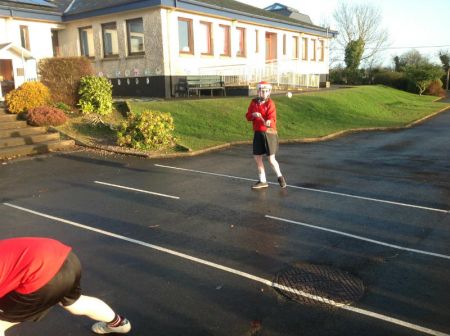A P6 hurler practising some hurling skills.