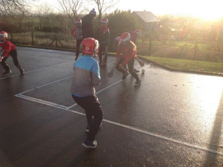 P6 & P7 enjoying a game of hurling during PE.