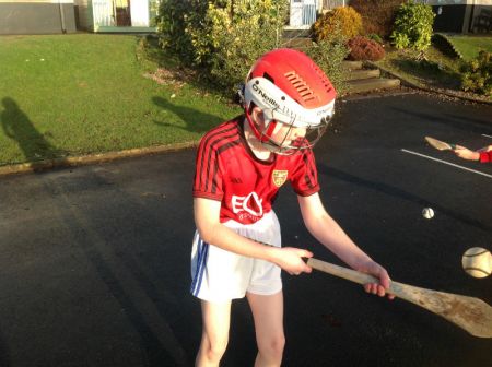 A P6 hurler practising some hurling skills.