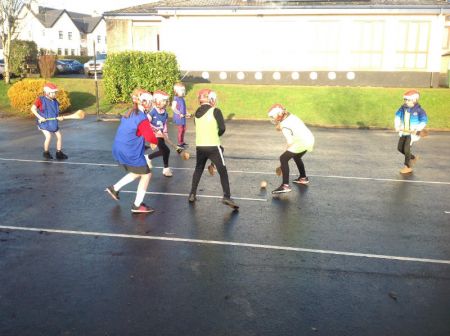 P6 & P7 enjoying a game of hurling during PE